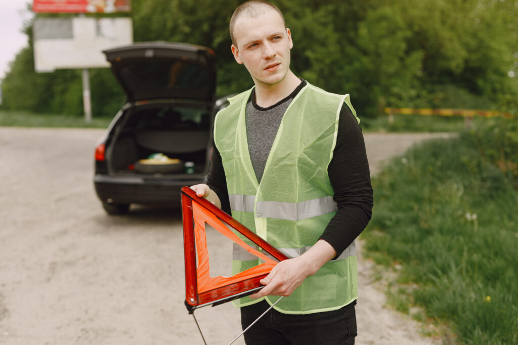 man holding a red triangle